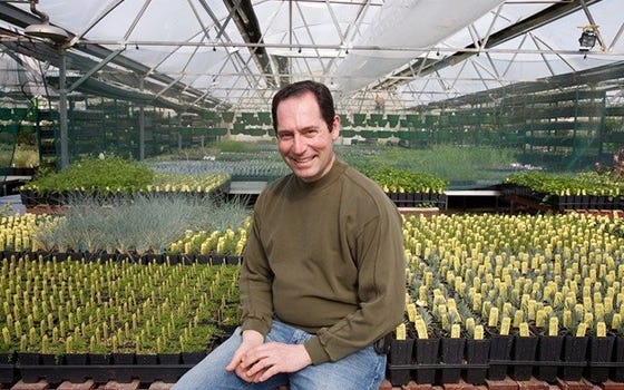 David Salman sitting in front of a garden